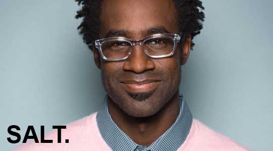 A man with glasses and a pink sweater.