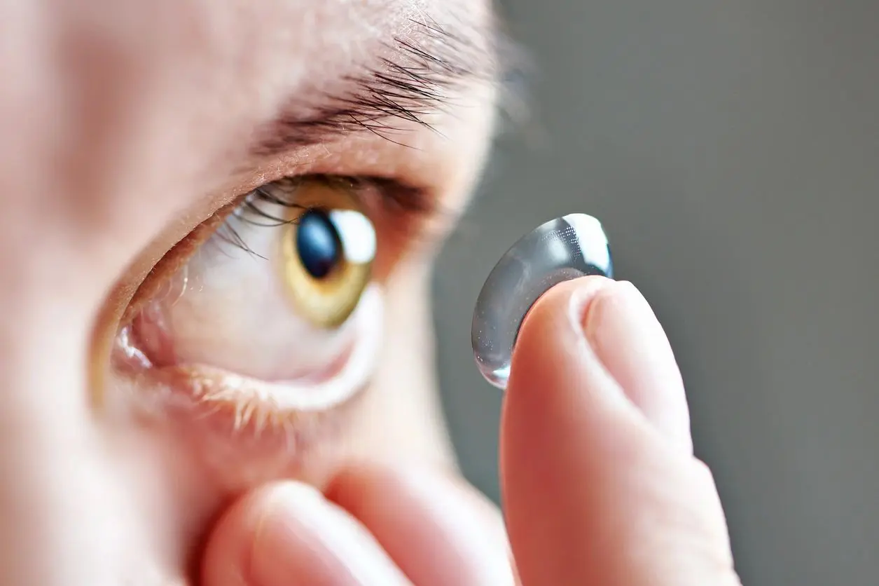 A person putting contact lens in his eye